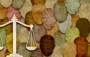 Paper cutout face of diverse culture together with scales of justice to convey racial equality and law and order